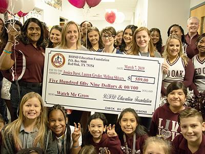 Education Foundation Prize Parade with teachers holding grant check 